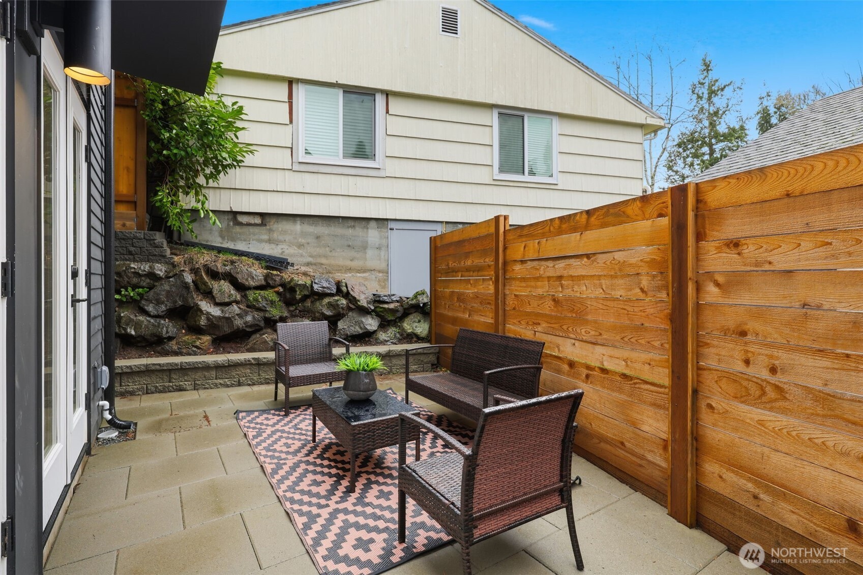 14304 1st Avenue Northwest Seattle, WA 98133 - Photo 4 of 18 a patio with table and chairs and potted plants