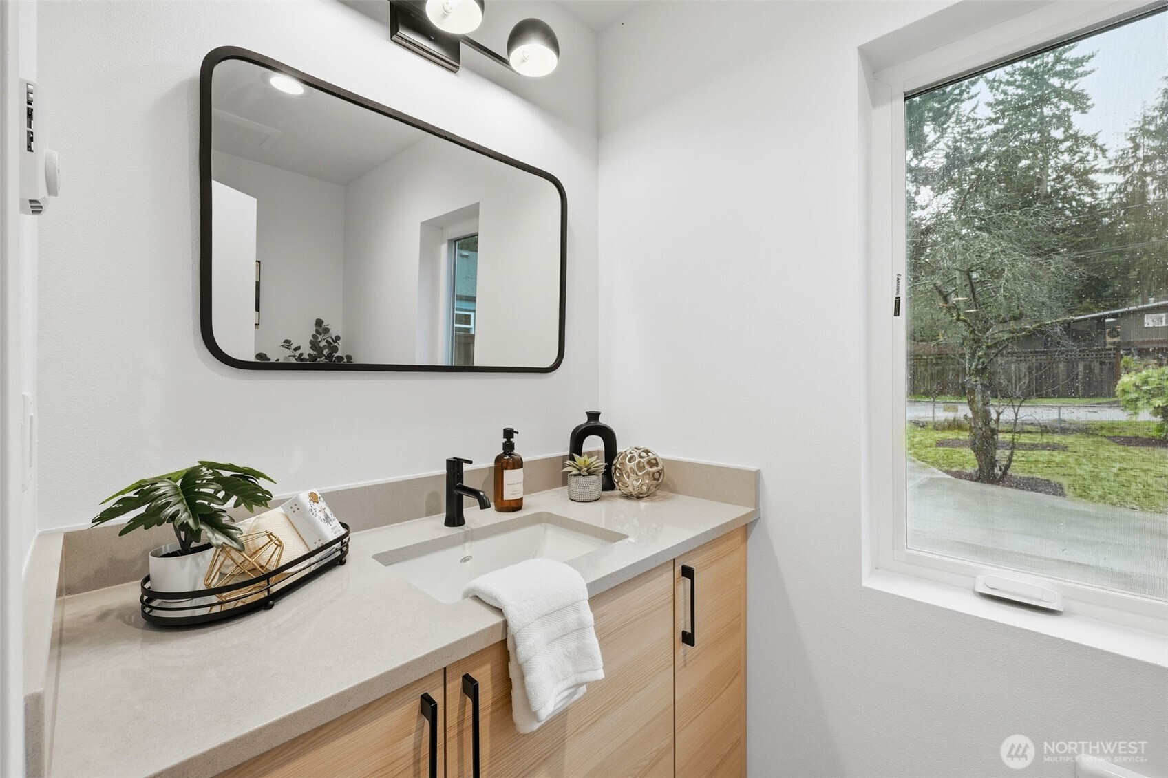 14304 1st Avenue Northwest Seattle, WA 98133 - Photo 10 of 18 a bathroom with a double vanity sink and mirror