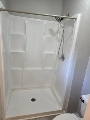 a bathroom with a glass shower door