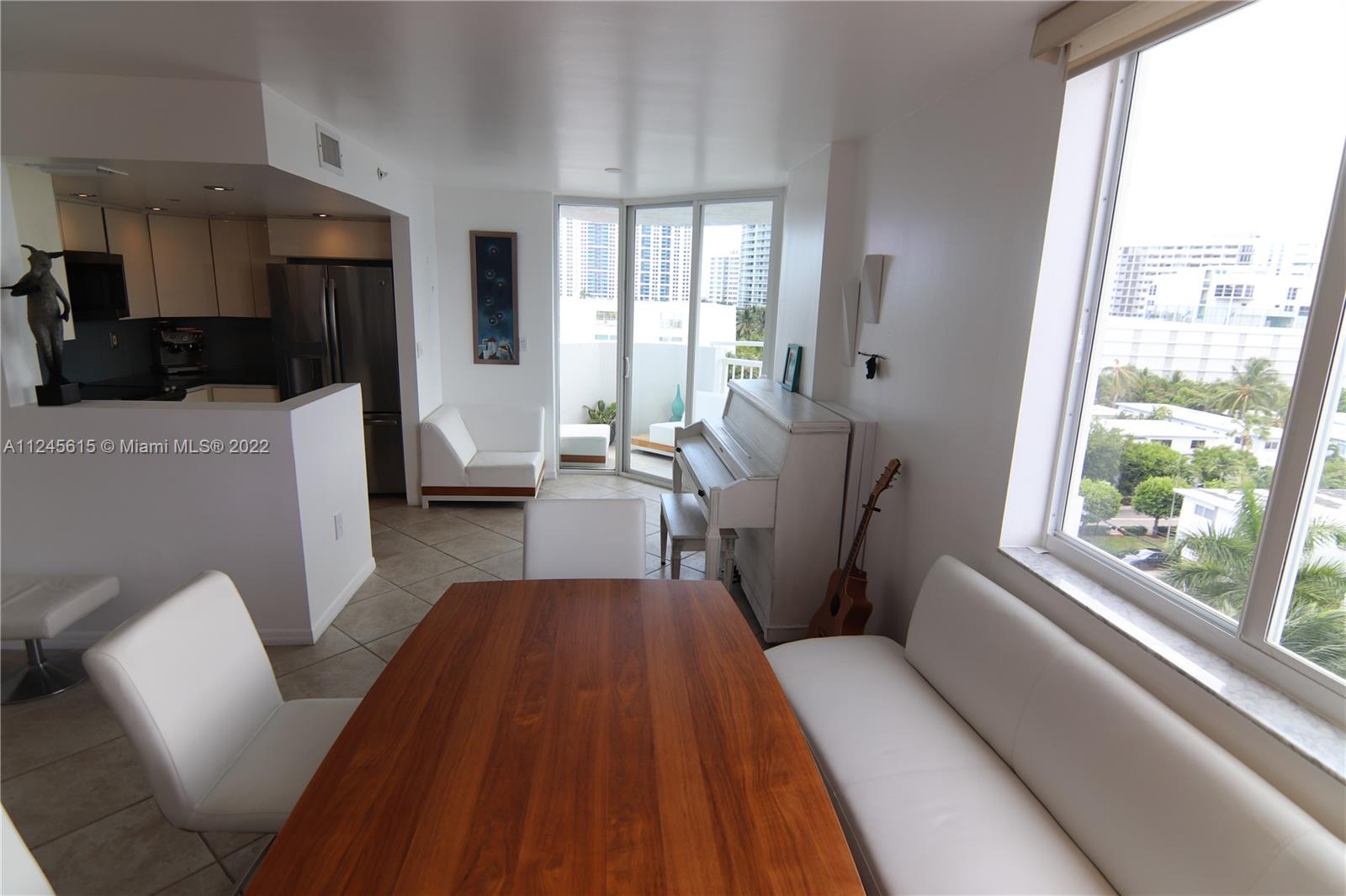 1621 Bay Road, Unit 708 Miami Beach, FL 33139 - Photo 16 of 20 a living room with furniture and a large window