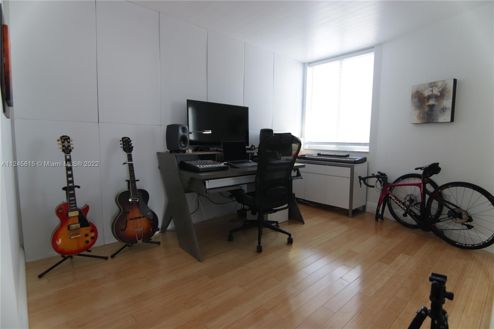 1621 Bay Road, Unit 708 Miami Beach, FL 33139 - Photo 8 of 20 a view of a workspace with furniture and a window