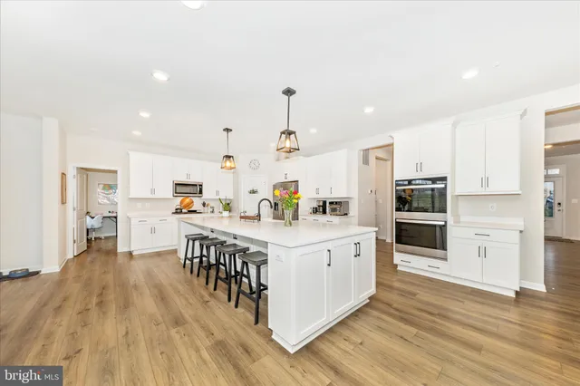 a kitchen with stainless steel appliances a refrigerator sink and microwave