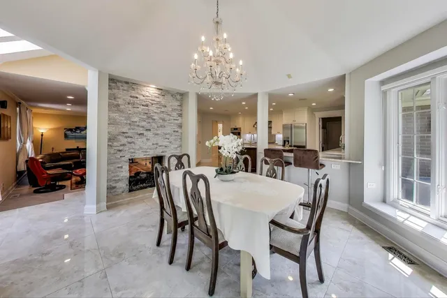a view of a dining room with furniture and a chandelier