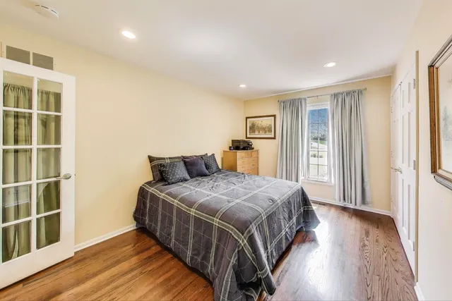 a bedroom with a large bed and a window