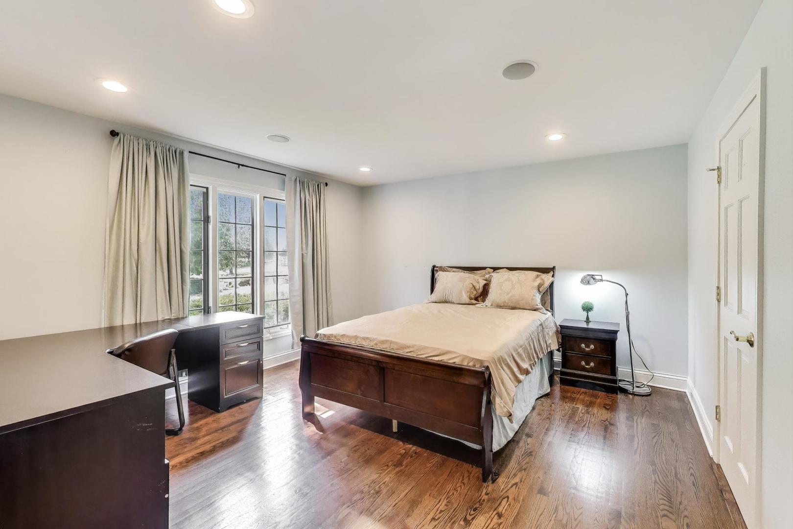 1920 Wedgewood Drive Lake Forest, IL 60045 - Photo 28 of 53 a bedroom with a bed and wooden floor