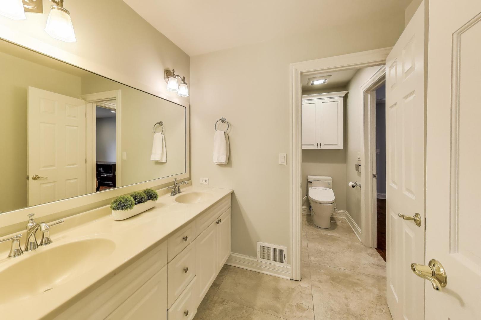 1920 Wedgewood Drive Lake Forest, IL 60045 - Photo 30 of 53 a spacious bathroom with a double vanity sink mirror and toilet