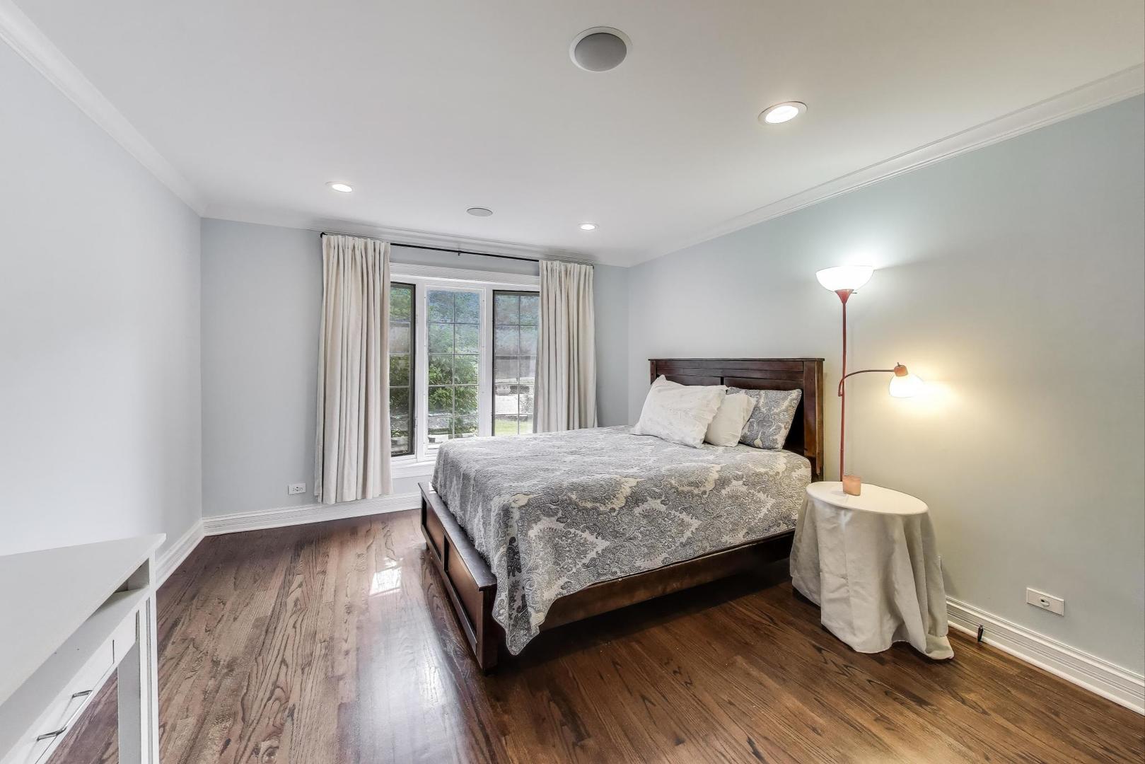 1920 Wedgewood Drive Lake Forest, IL 60045 - Photo 32 of 53 a bedroom with a bed and wooden floor