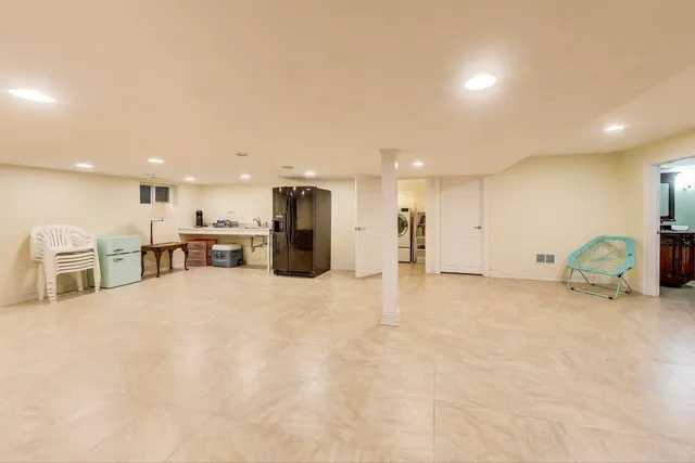 a spacious bedroom with a bed and a window