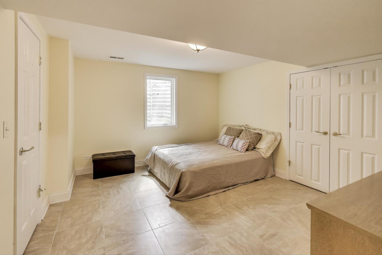 1920 Wedgewood Drive Lake Forest, IL 60045 - Photo 39 of 53 a spacious bedroom with a bed and a window
