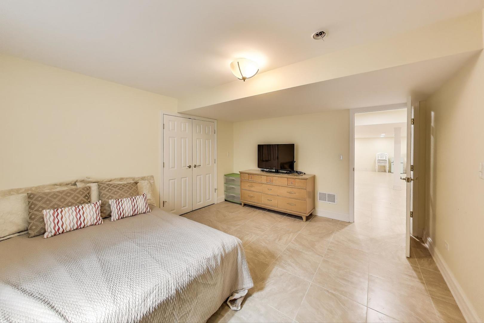 1920 Wedgewood Drive Lake Forest, IL 60045 - Photo 40 of 53 a bedroom with a bed and a television