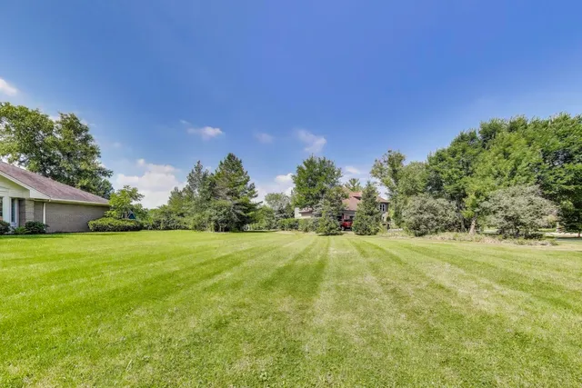 a front view of a house with a yard table and chairs