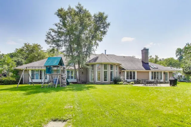 a view of a house with sitting area and garden