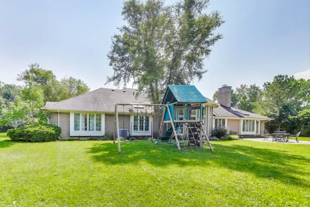 a view of a backyard with sitting area