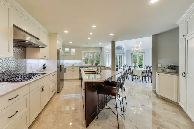 a large kitchen with cabinets table and chairs