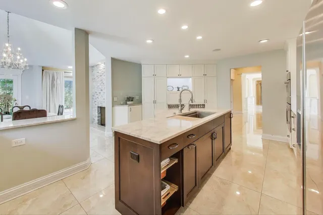 a kitchen with stainless steel appliances granite countertop a sink and a refrigerator