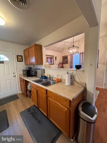 a living room with lots of furniture and kitchen view