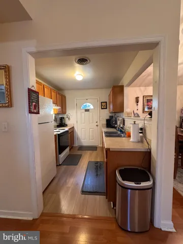 a kitchen with a refrigerator and a sink