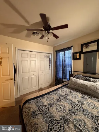 a bedroom with a bed and a view of bathroom