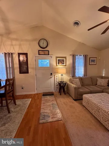 a living room with couches and painting on the wall