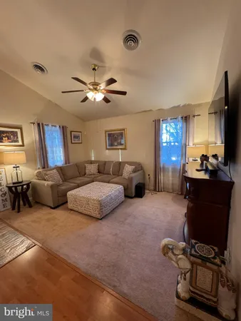 a living room with furniture gym equipment and a window