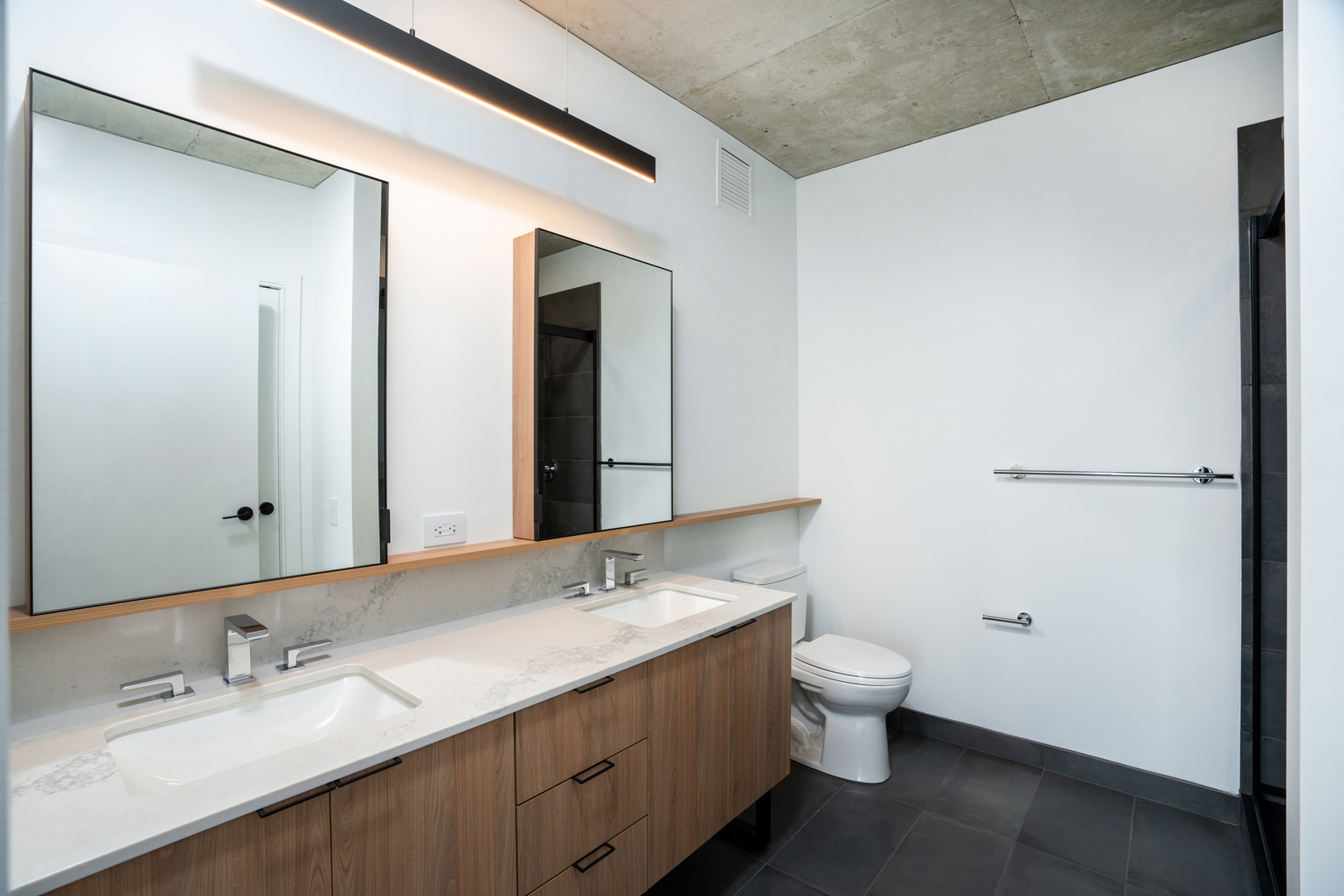 234 West Polk Street, Unit 3708 Chicago, IL 60605 - Photo 7 of 33 a bathroom with a double vanity sink toilet and mirror