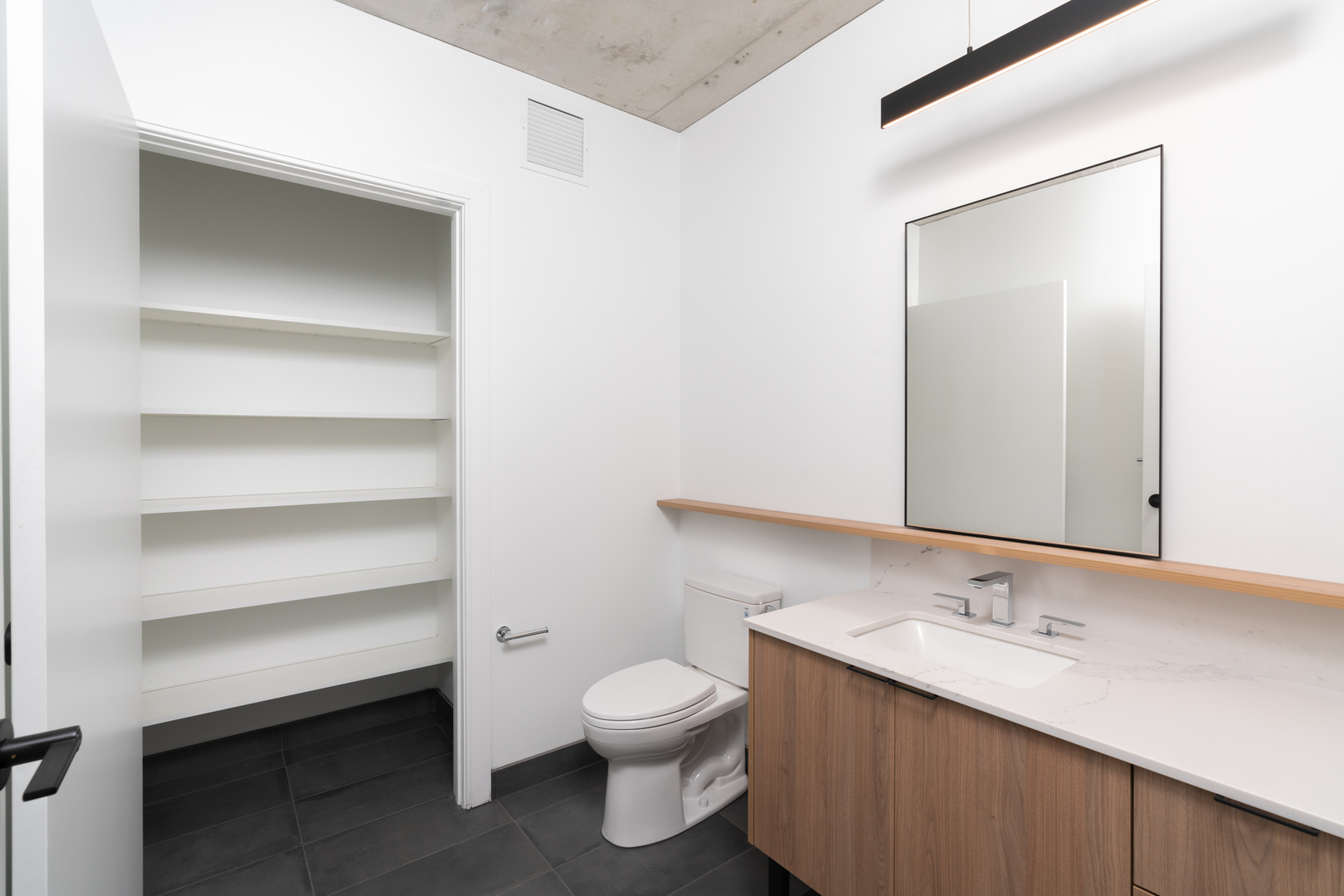 234 West Polk Street, Unit 3708 Chicago, IL 60605 - Photo 8 of 33 a bathroom with a granite countertop sink toilet and a mirror