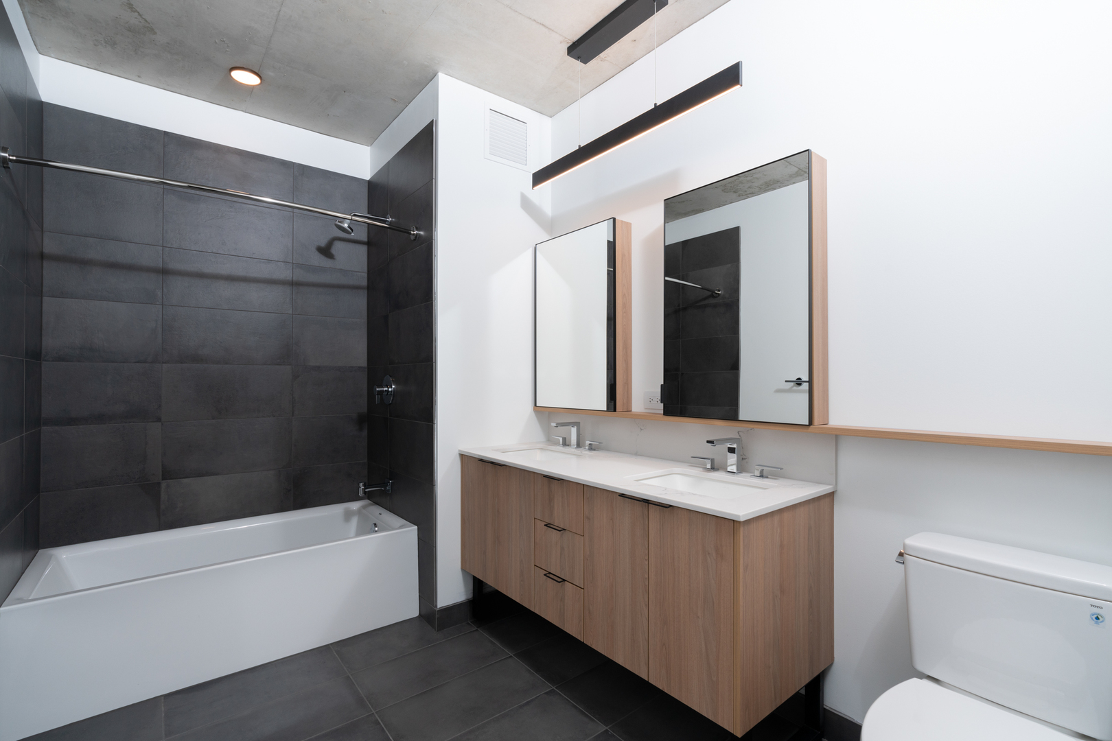 234 West Polk Street, Unit 3708 Chicago, IL 60605 - Photo 10 of 33 a bathroom with a bathtub shower sink mirror and toilet