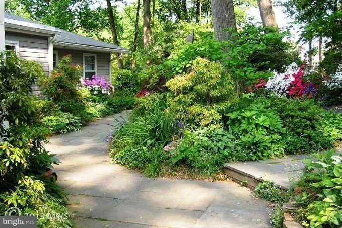 10409 Gary Road, Unit FRONT Potomac, MD 20854 - Photo 2 of 14 a view of a house with potted plants
