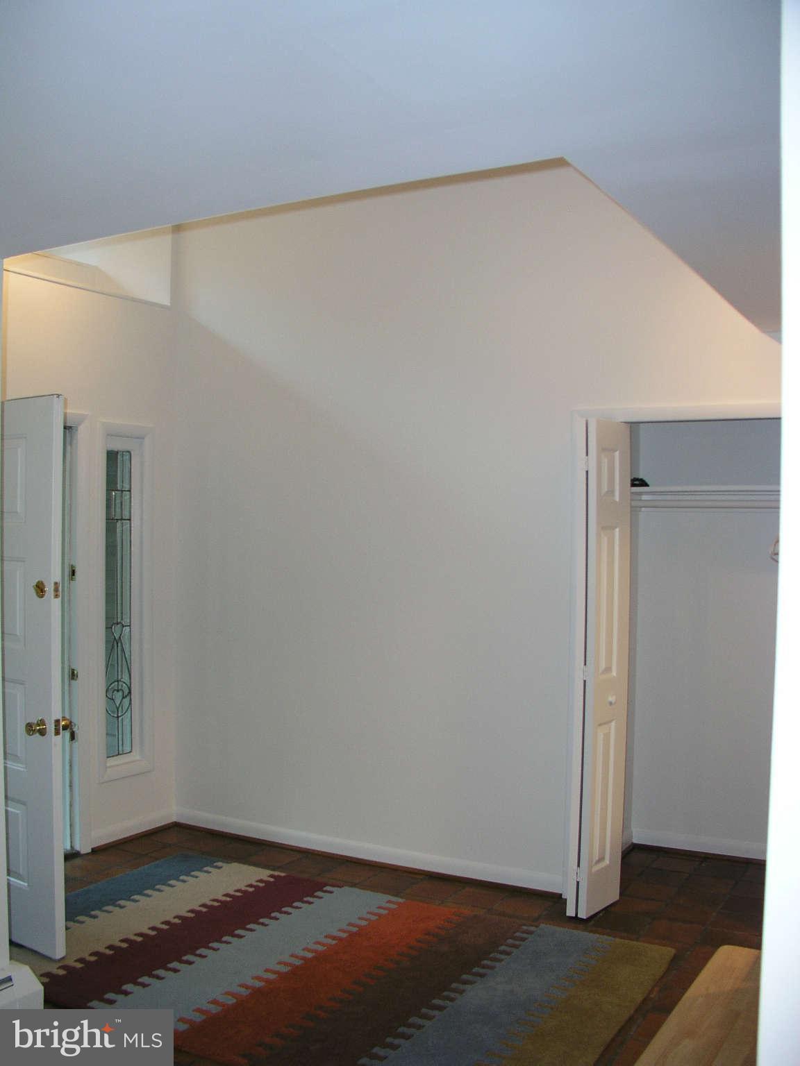 10409 Gary Road, Unit FRONT Potomac, MD 20854 - Photo 3 of 14 an empty room with wooden floor and windows