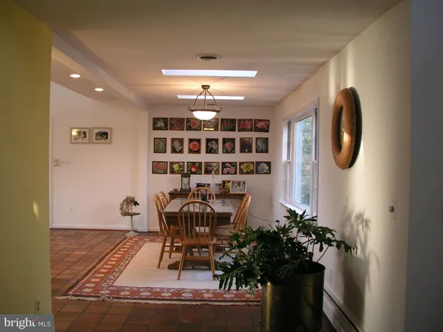 a view of a dining room with furniture and chandelier