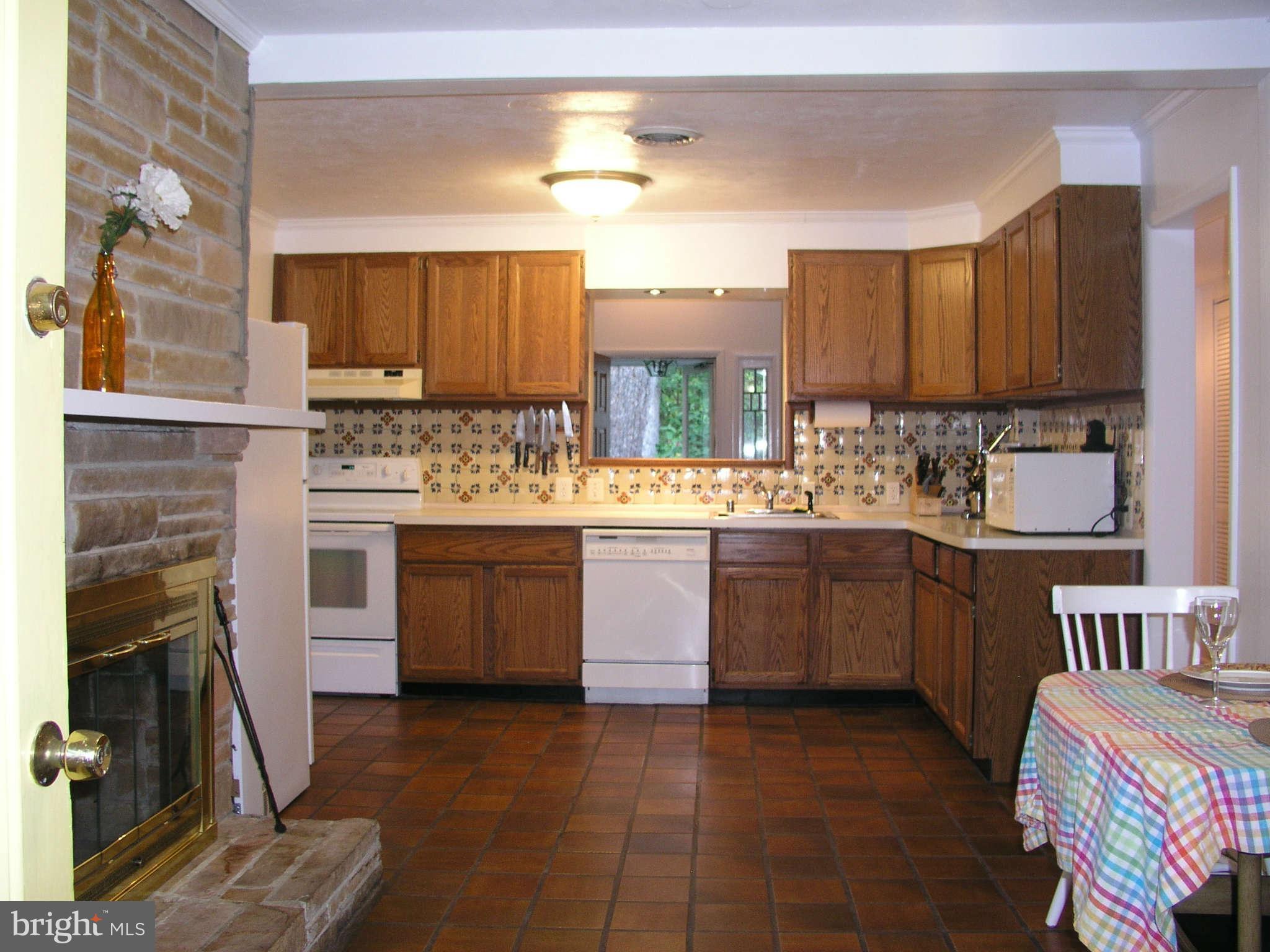 10409 Gary Road, Unit FRONT Potomac, MD 20854 - Photo 9 of 14 a kitchen with a sink stove and cabinets