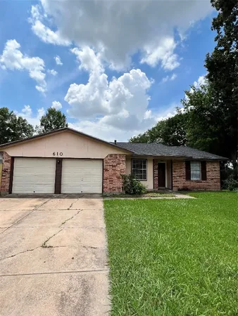 a front view of house with yard and trees