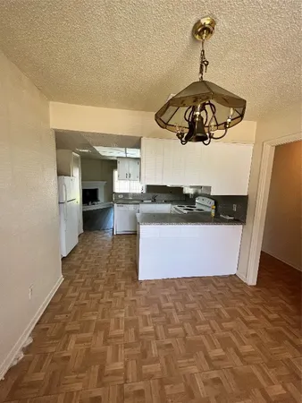 a view of a kitchen with a sink stainless steel appliances and cabinets