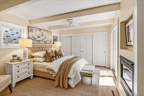 a bathroom with a white tub shower and mirror