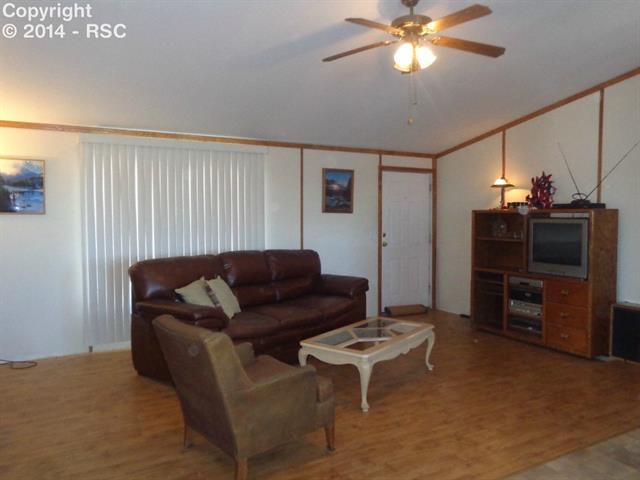 4665 North Log Road Peyton, CO 80831 - Photo 5 of 13 Another view of the living room - there is plenty of space for all of your furniture!