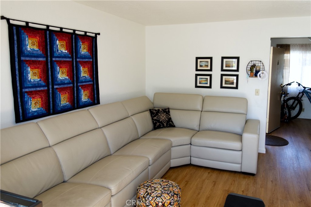 171 Brisco Road, Unit 6 Arroyo Grande, CA 93420 - Photo 4 of 12 a living room with a couch and a bookshelf