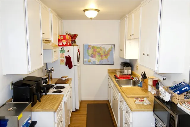 a kitchen with a refrigerator and a stove