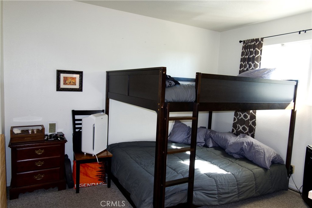 171 Brisco Road, Unit 6 Arroyo Grande, CA 93420 - Photo 8 of 12 a bedroom with a bed and furniture