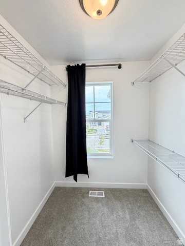 3359 Eurasian Crane Road Clinton, UT 84015 - Photo 23 of 71 Walk in closet featuring light colored carpet