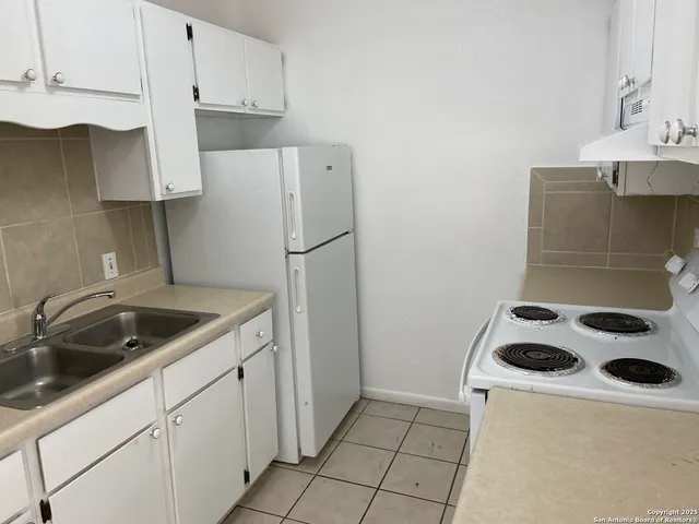 a kitchen with a sink a stove and refrigerator