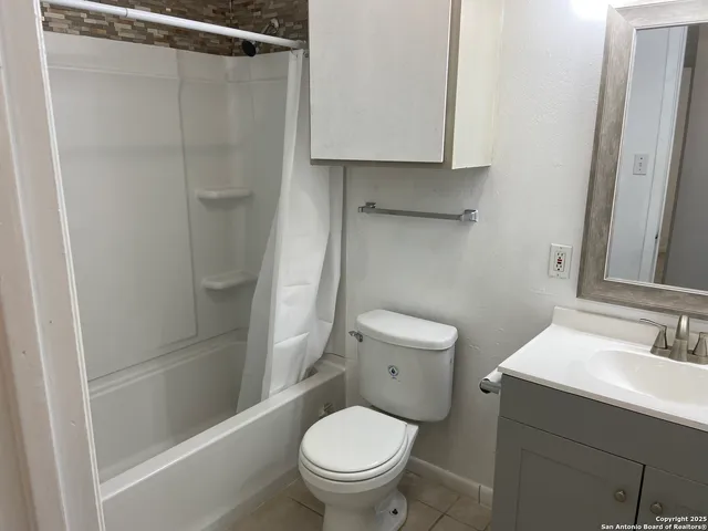 a bathroom with a toilet a sink and shower