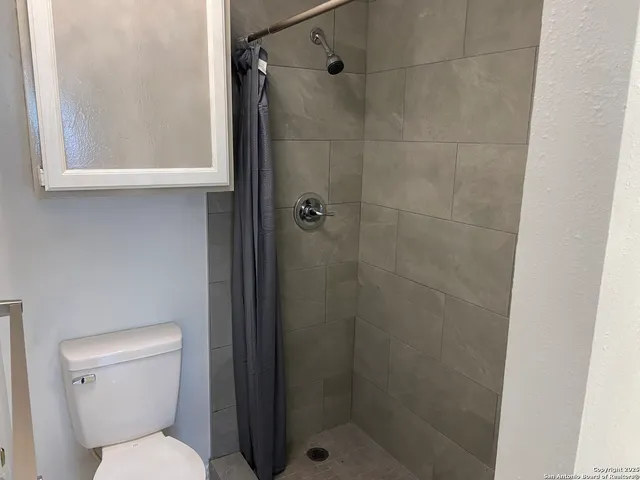 a white toilet sitting next to a bathroom sink