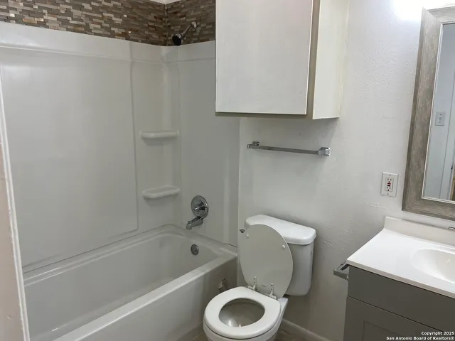 a bathroom with a toilet and a bathtub