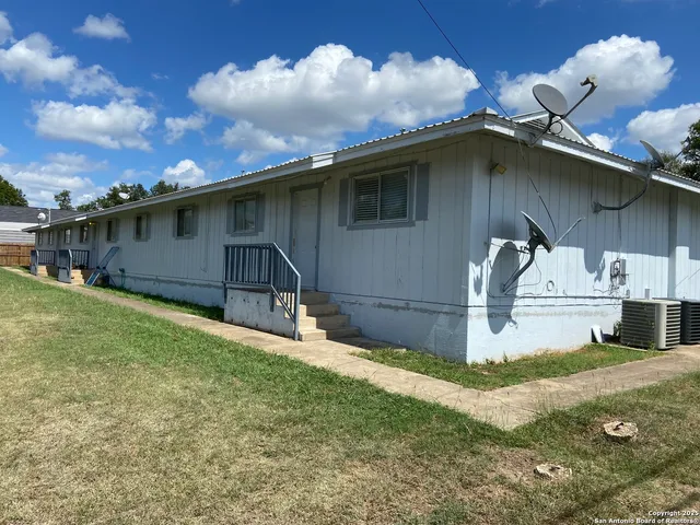 a house with lots of trees in the background