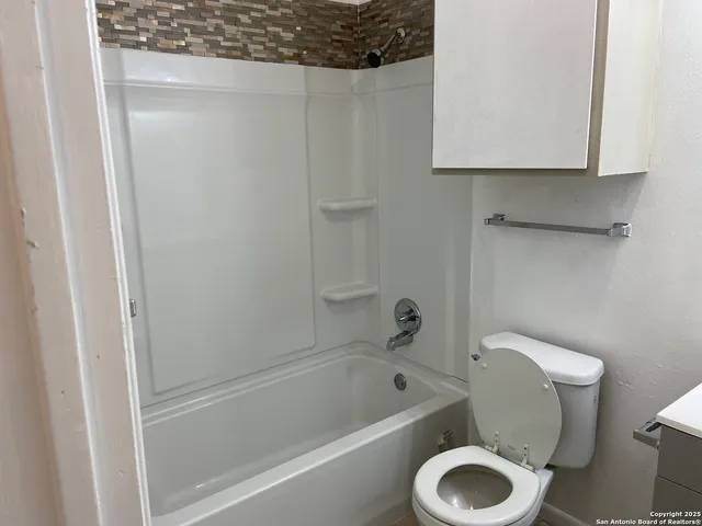 a bathroom with a toilet and a bathtub