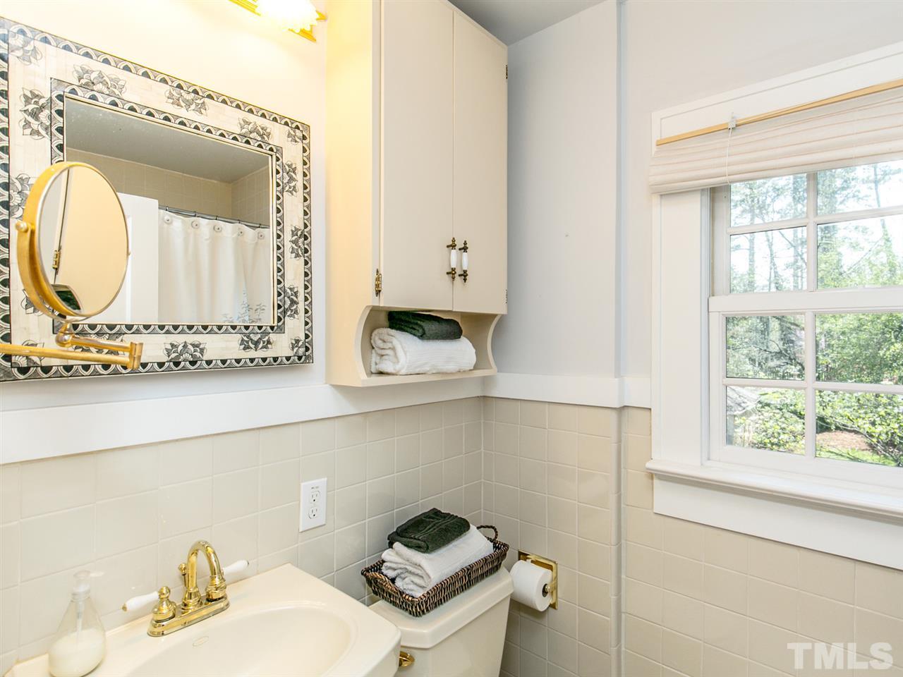 2206 Byrd Street Raleigh, NC 27608 - Photo 22 of 25 a bathroom with a sink and a mirror