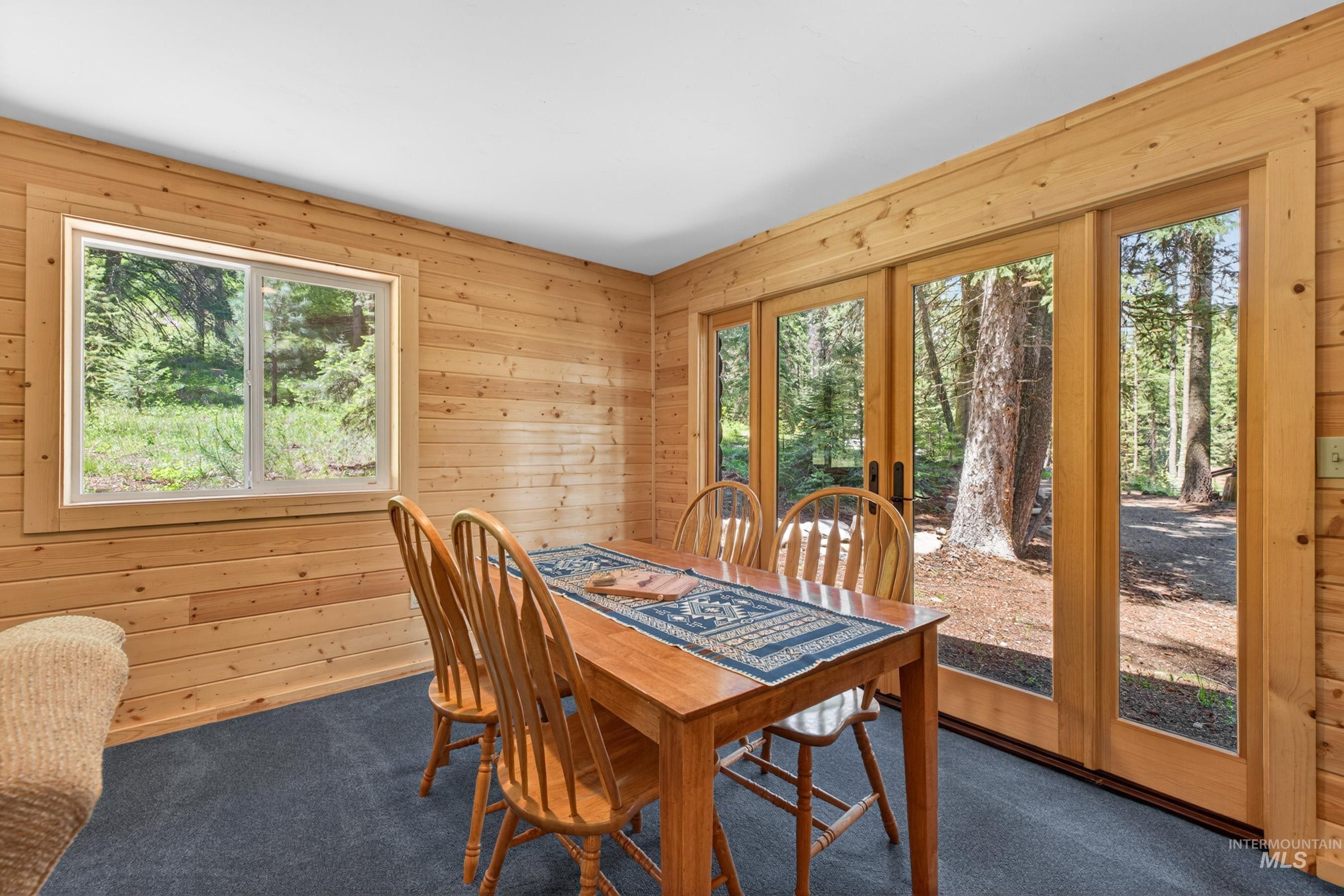 2339 West Mountain Road Donnelly, ID 83615 - Photo 25 of 37 Wood-paneled room featuring a large picture window and sliding glass doors