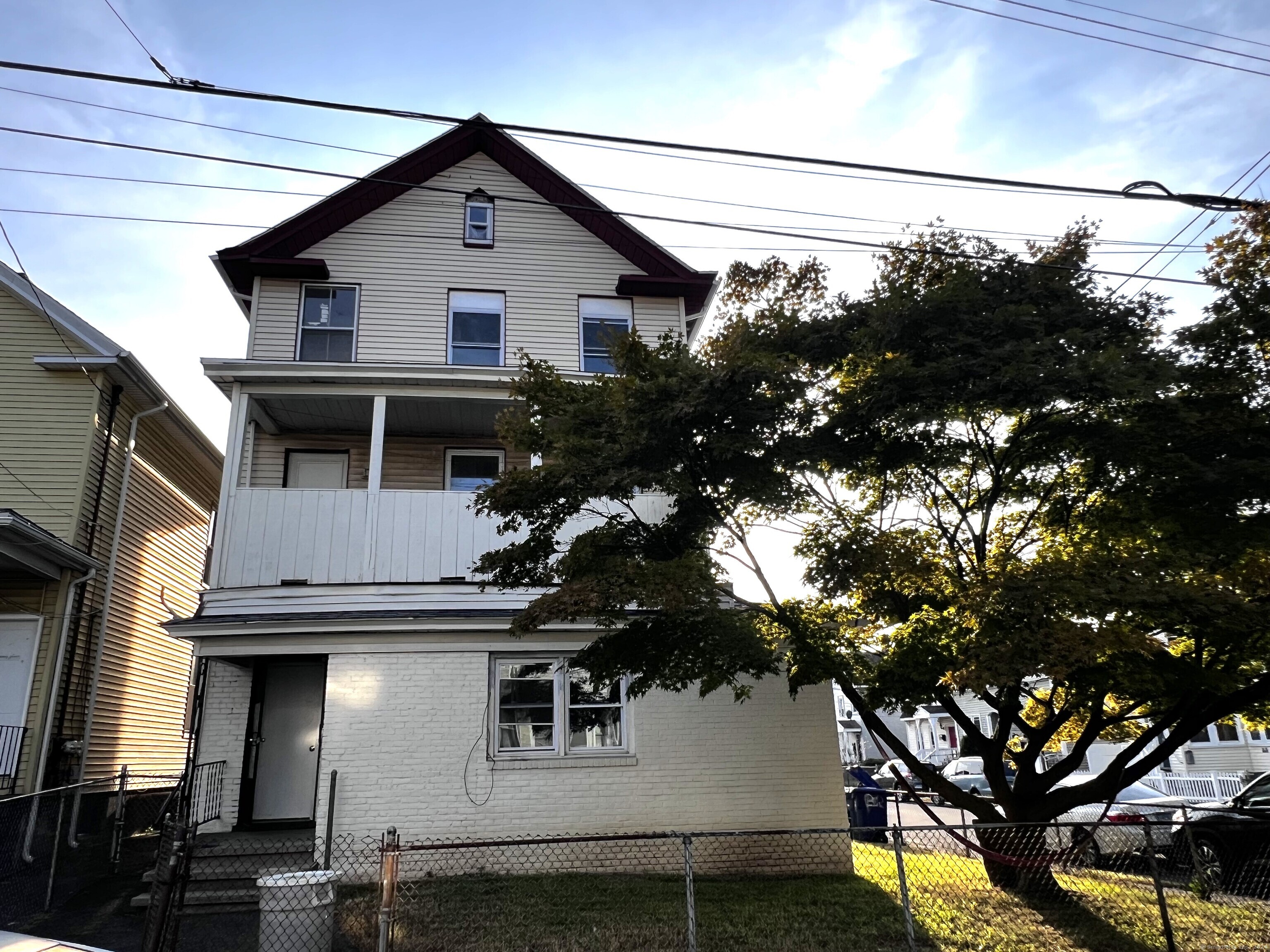 a house that has a tree in front of it