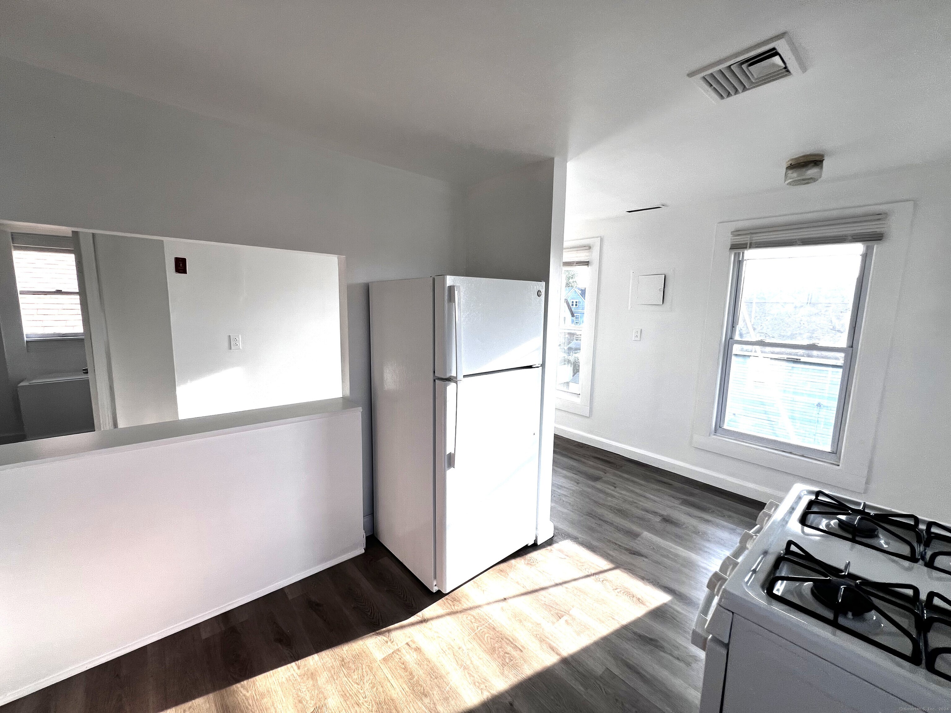 83 Seeley Street, Unit 3 Bridgeport, CT 06604 - Photo 4 of 12 a kitchen with a refrigerator and a stove top oven