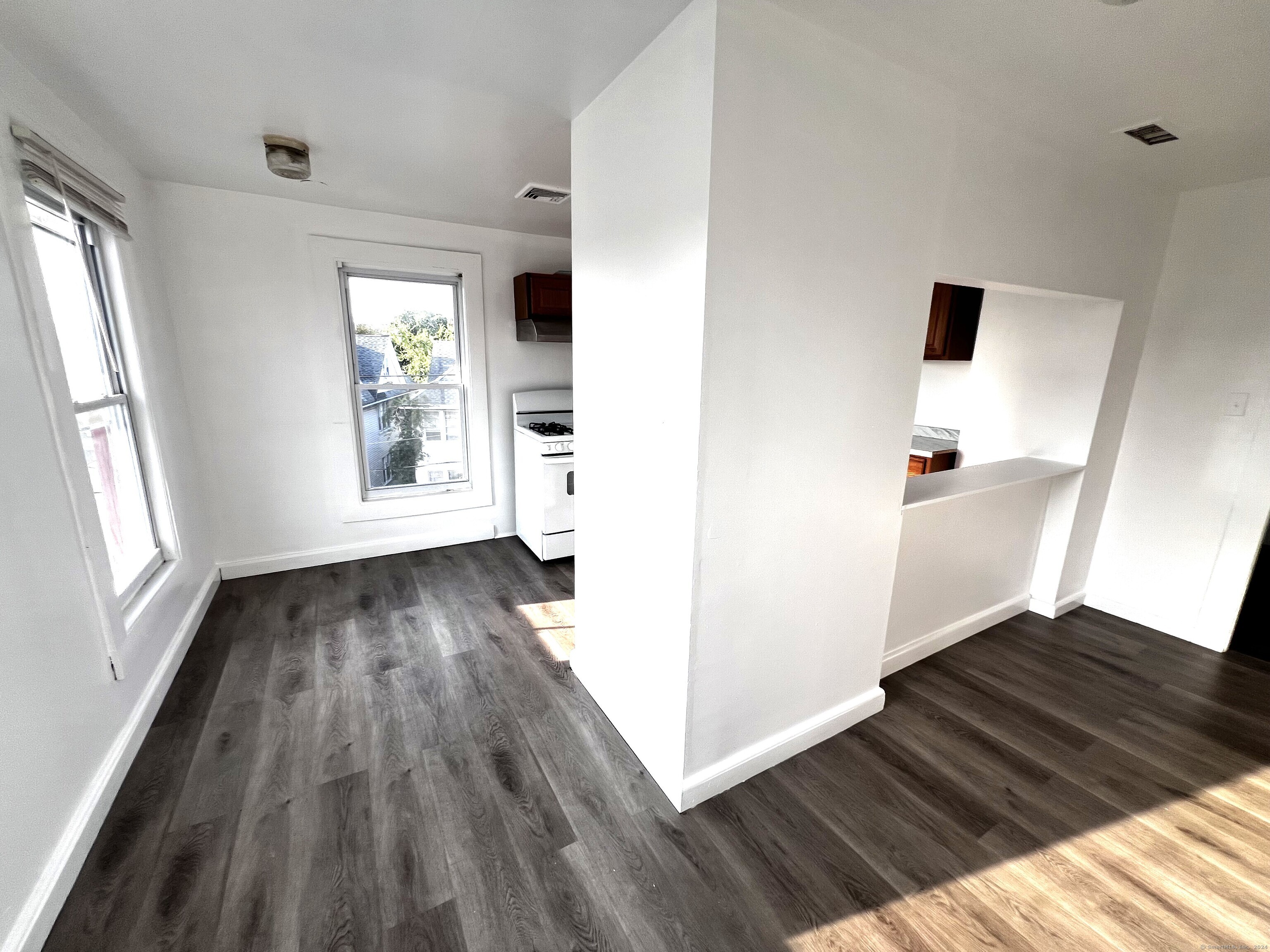 83 Seeley Street, Unit 3 Bridgeport, CT 06604 - Photo 5 of 12 wooden floor in an empty room with a window